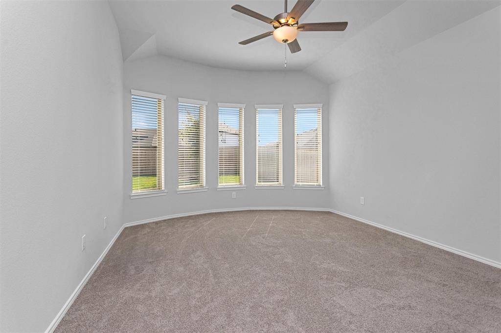 Retreat to the luxurious Primary Bedroom featuring a beautiful wall of windows for natural light!
