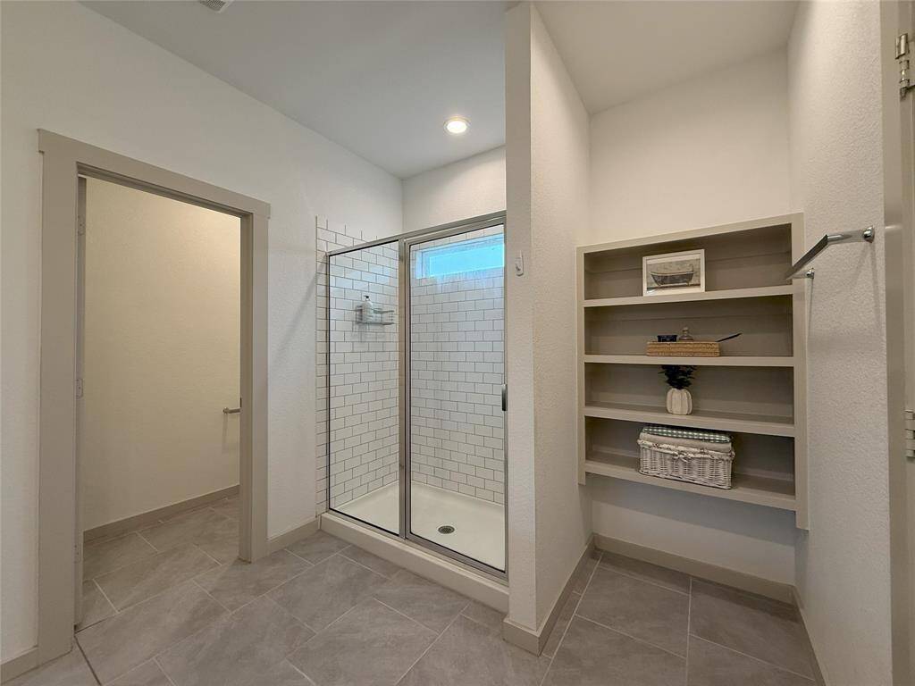 Spacious downstairs master bedroom offers convenience and comfort.