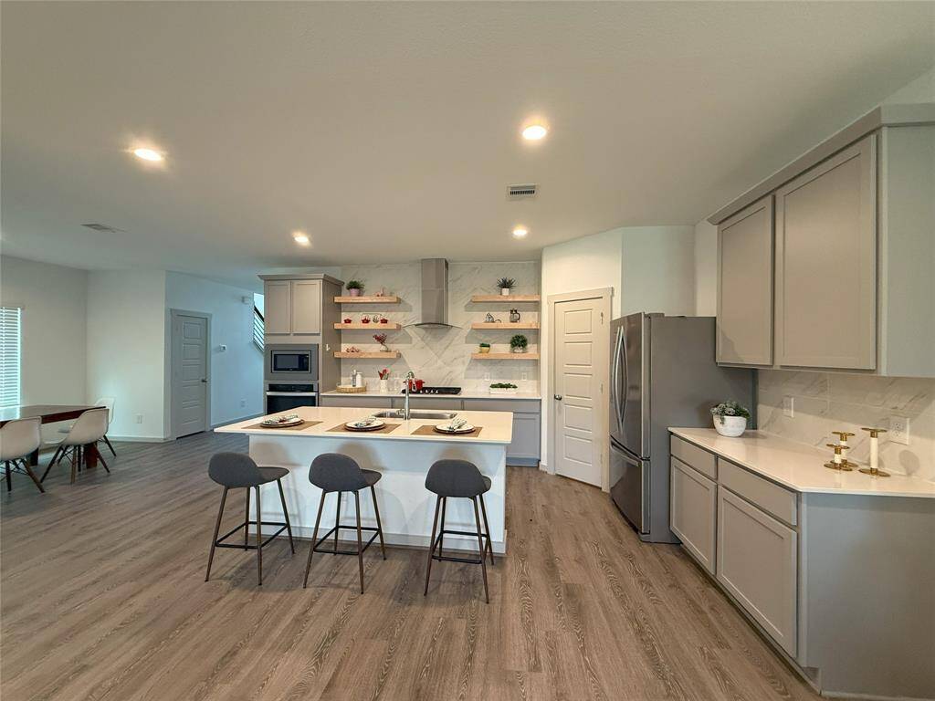 Modern stainless-steel refrigerator included.