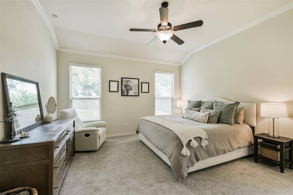 Primary suite overlooks backyard.
