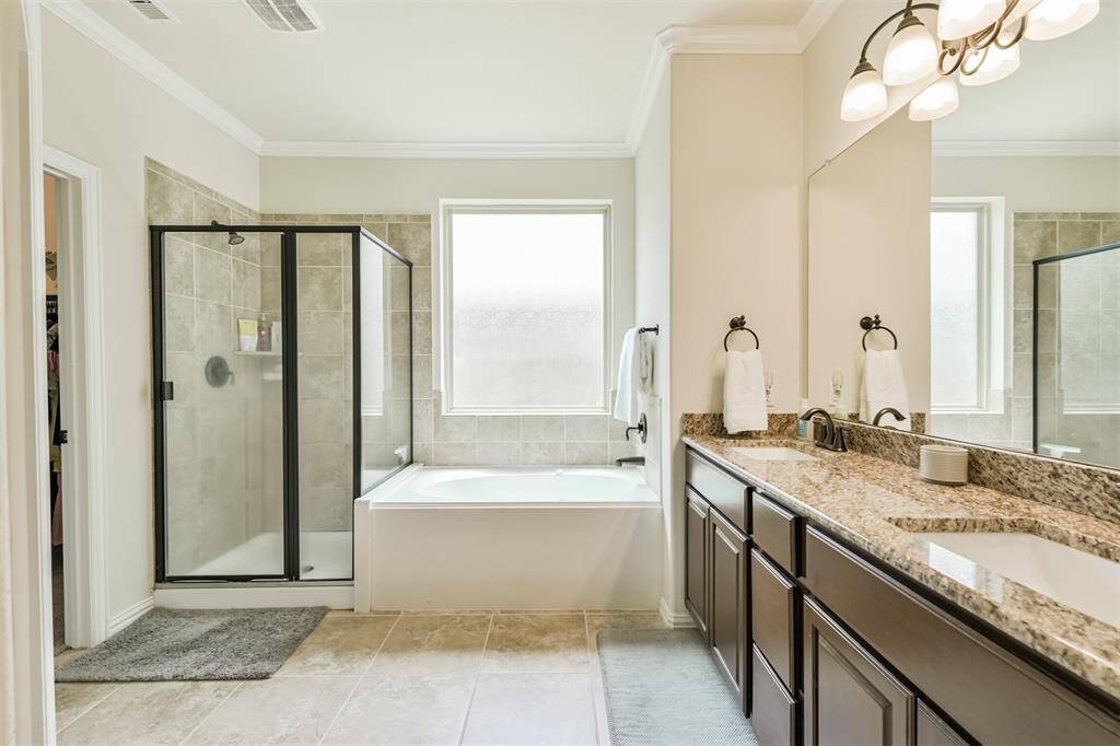 Separate shower and jetted tub in primary ensuite.