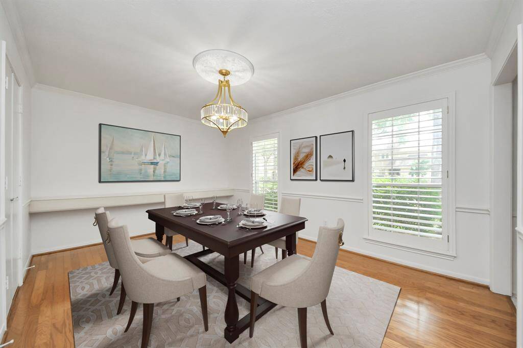 Formal Dining room with serving bar, new chandelier and new paint. Virtually staged