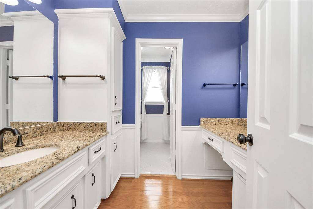 secondary bath with vanity area on one side with second sink