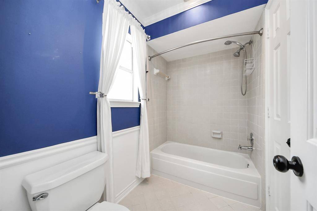Secondary bath with pass through to bedroom and separate from sink/vanity area.