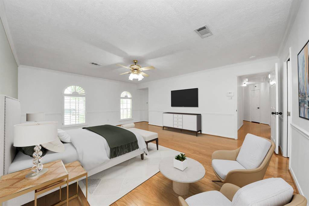 Large primary bedroom with wood floors and NEW paint! Virtually Staged