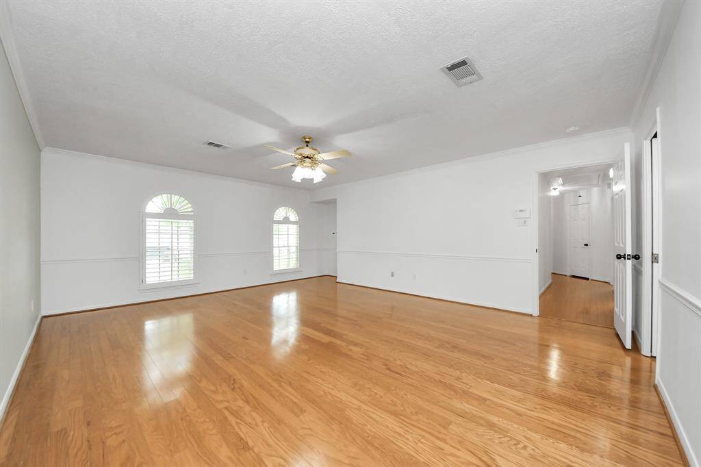 Large primary bedroom with wood floors and NEW paint!
