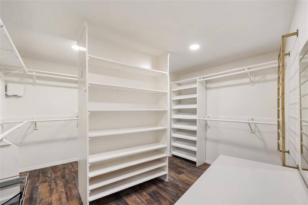 This impressively oversized walk-in closet offers room for it all—abundant hanging space, custom shelving for shoes and accessories, and thoughtful organization throughout. A dream setup for anyone who loves space, style, and staying effortlessly organized.