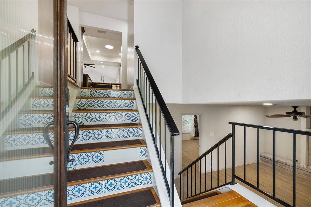 Just through the front door, a central staircase splits the home’s main living spaces—leading up to the heart of the home and down to a spacious living area. It’s a layout that invites movement, function, and flow.