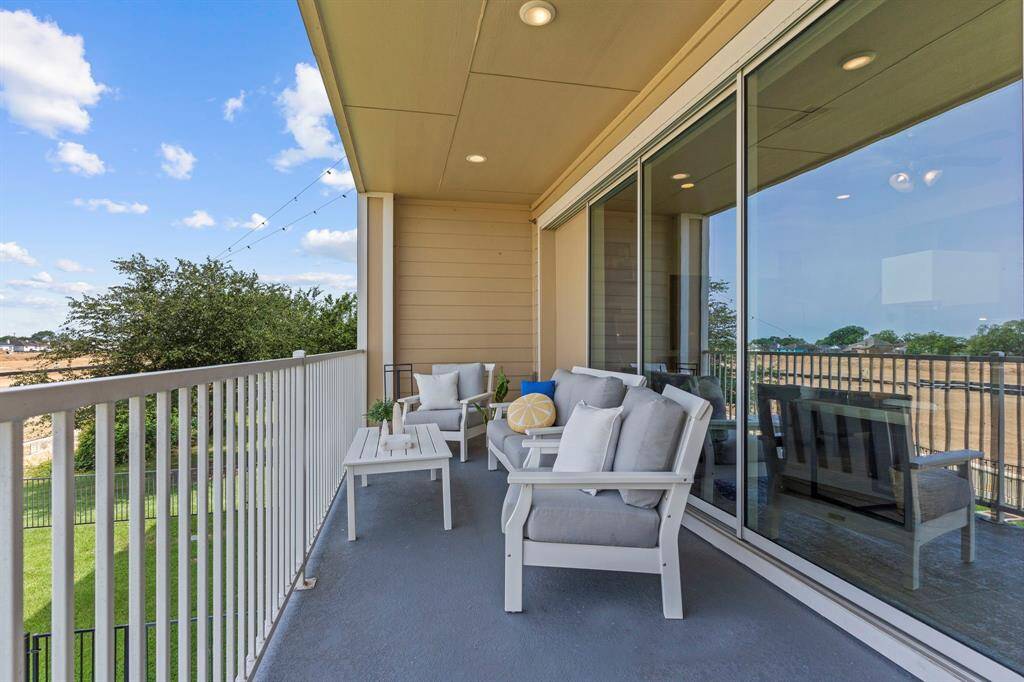 Beautifully connected open-concept space featuring elegant tile floors and a spacious living area that flows effortlessly into the dining and kitchen zones—perfect for both entertaining and everyday living.