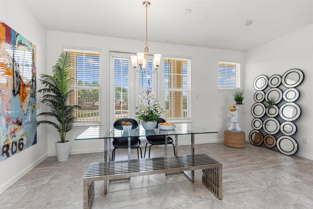 Designed for flow and function, this open-concept space leads from the kitchen into the living and dining areas—offering ample cabinetry, a built-in desk nook, and a light-filled, seamless layout.