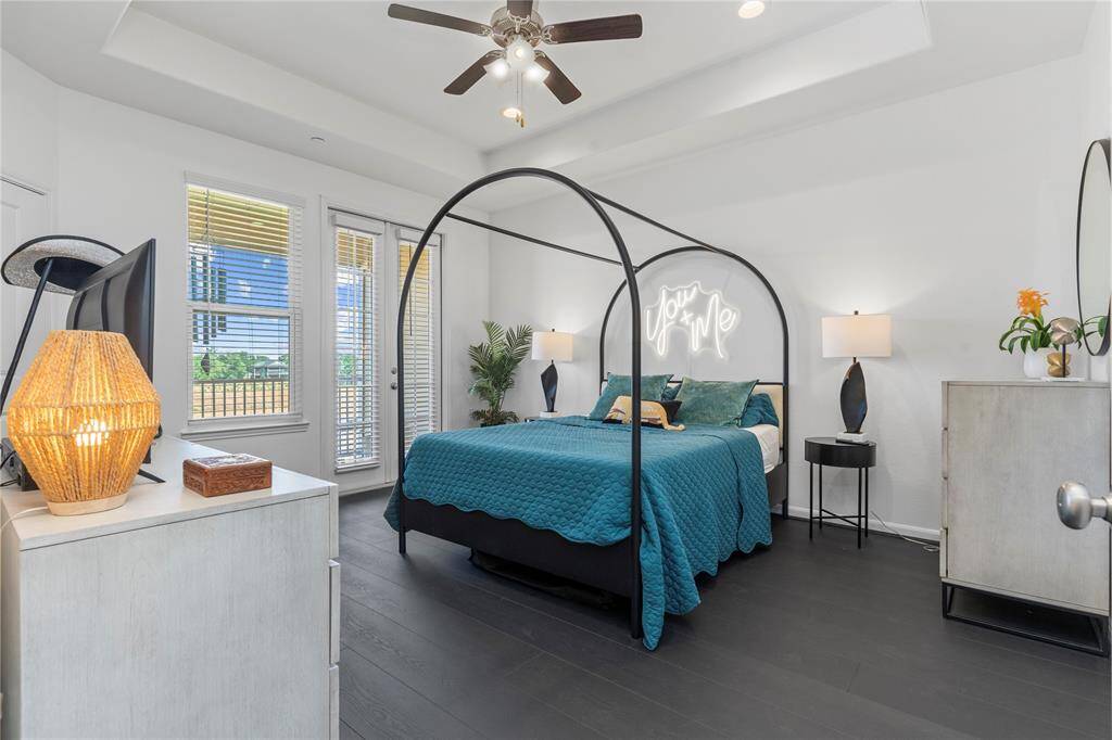 A different angle of the owner’s retreat reveals elegant flooring, a walk-in closet, and easy flow into the en suite bath. This bedroom is as functional as it is relaxing.