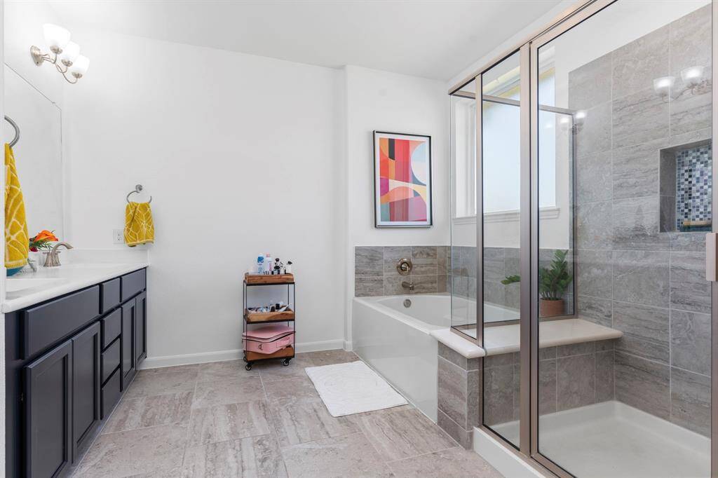 Enjoy the best of both worlds with a spacious spa-style layout that includes a soaking tub and adjacent glass-enclosed walk-in shower. This setup creates a relaxing retreat right at home.