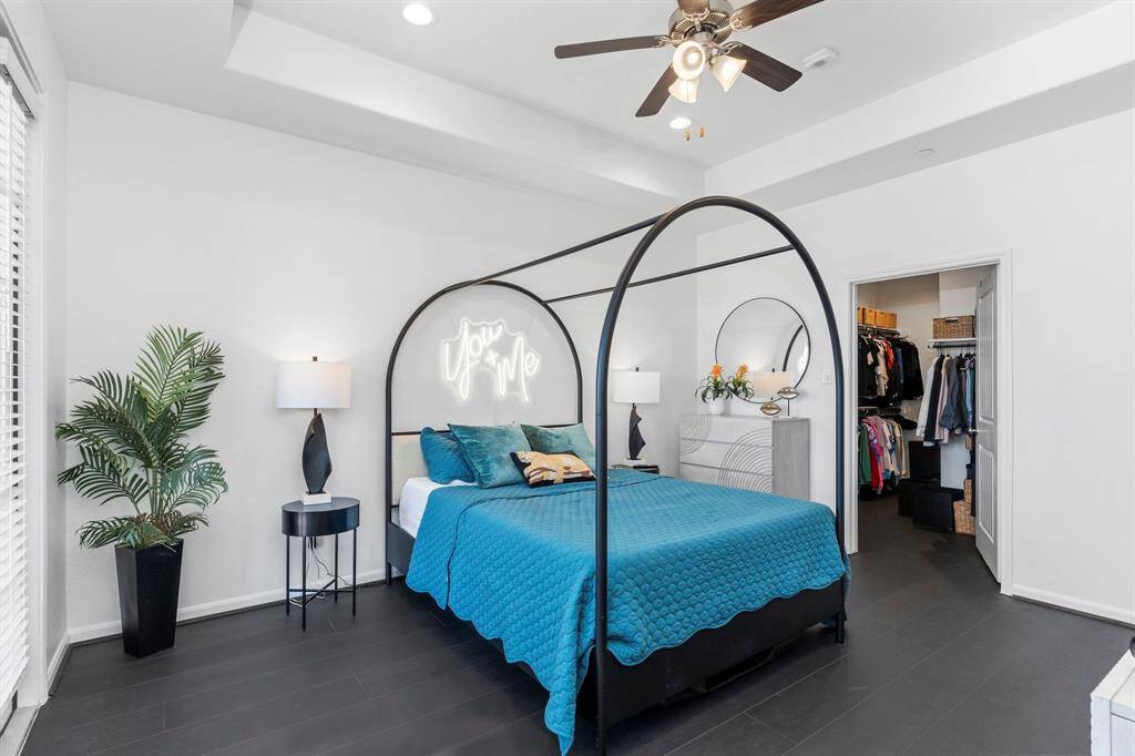 A well-appointed full bathroom featuring a tiled shower/tub combination, built-in storage shelves, and contemporary fixtures. Conveniently located to serve both guest bedrooms.