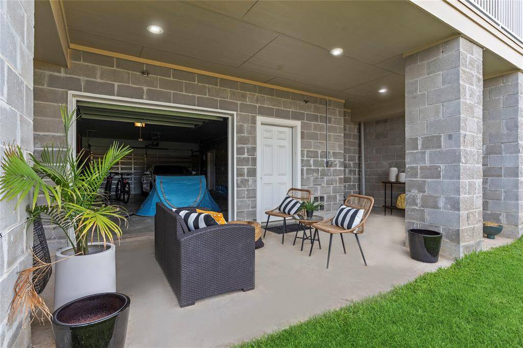 A full view of the building’s rear highlights the cohesive design and smart use of space, with covered patios, multiple balconies, and generous backyard fencing for every unit.  Sprinkler system!  Low property taxess!