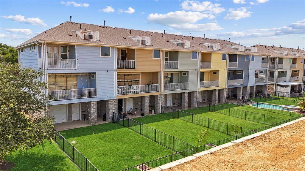 A stunning aerial perspective reveals just how close this beautiful townhome is to the water. Set within a lushly landscaped, master-planned gated community, you're never far from nature, views, and serenity.