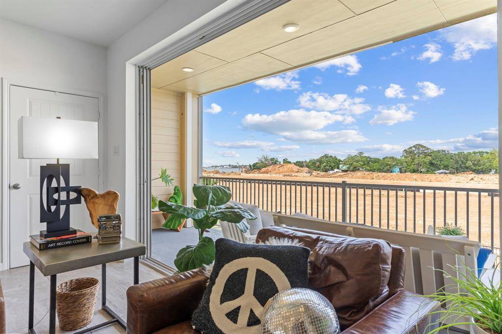 From this corner view, the depth and functionality of the covered balcony are on full display. Protected from the elements, it’s the perfect place to read, entertain, or simply breathe in the fresh lake air. The view stretches beyond the neighborhood for a relaxing sense of space and openness.