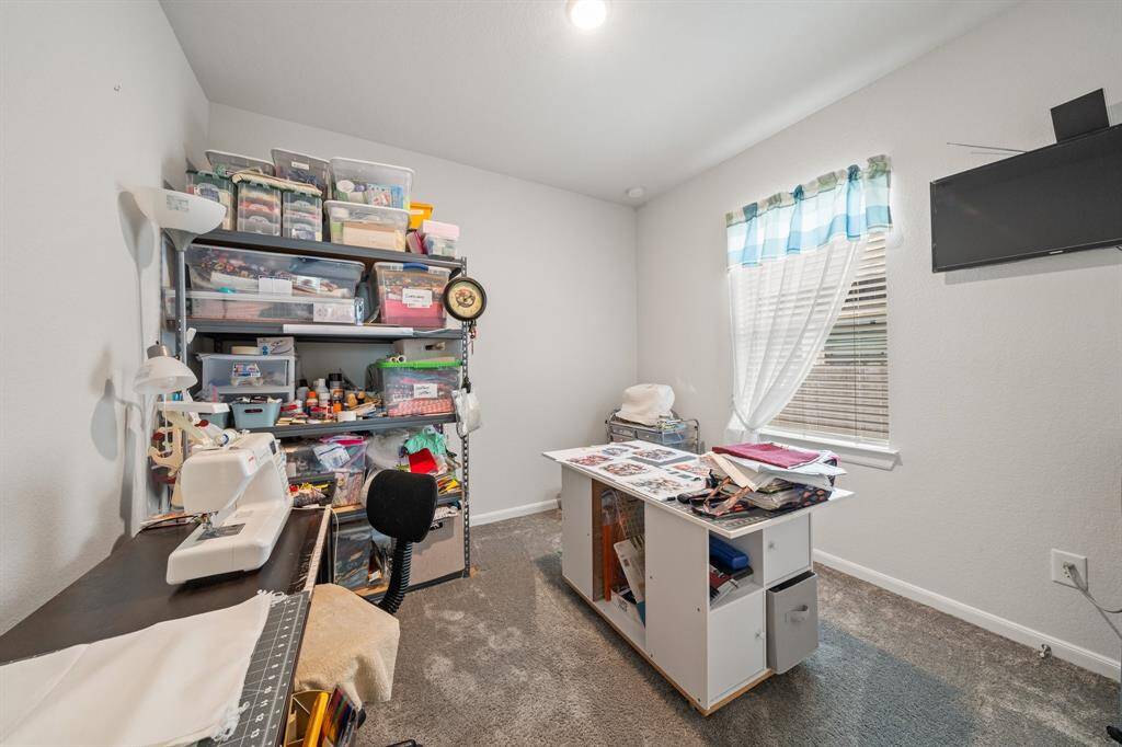 Secondary bedroom #3 being used as a creative workspace.