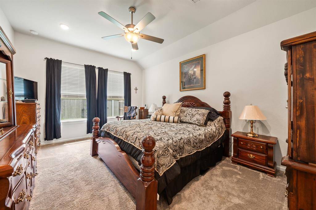 Spacious primary bedroom with vaulted ceilings.