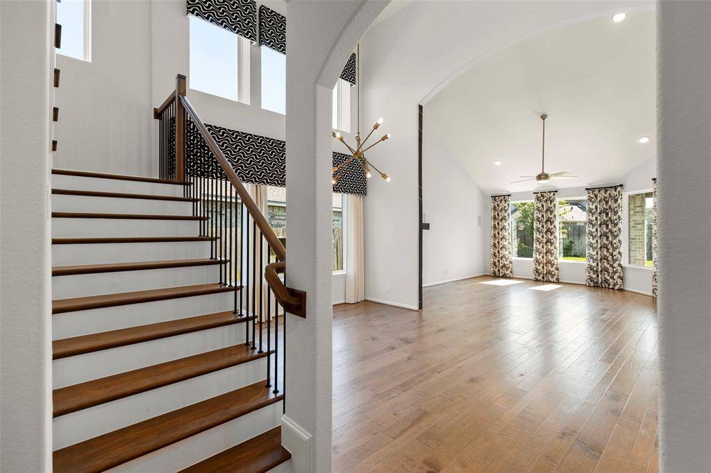 Elegant and wide wood stairs with wrought iron