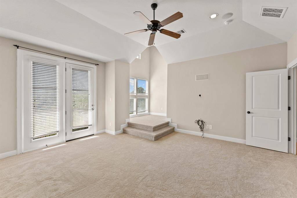 Oversized primary bedroom with unique step up sitting area