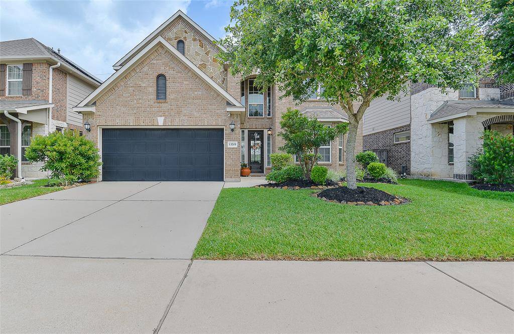 The curb appeal is undeniable—fresh mulch, neatly trimmed trees, and lush, green grass create a well-manicured and inviting entrance, offering a polished first impression that sets the tone for the comfort and care found throughout the home.