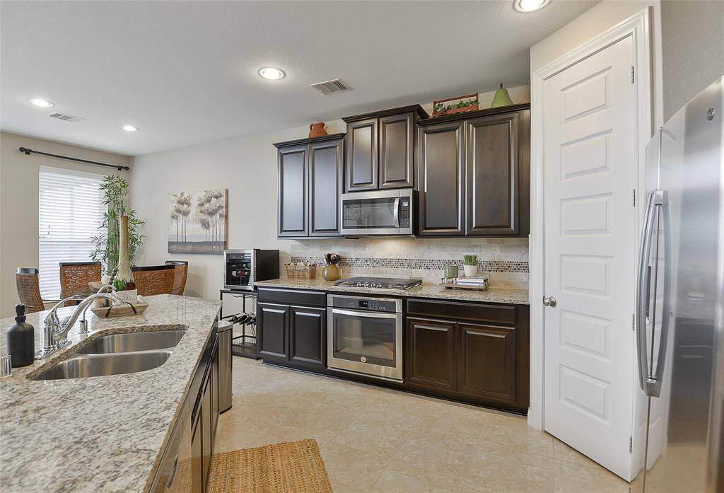 42 Inch Mahogany cabinets, stainless steel appliances and deep stainless-steel sink.