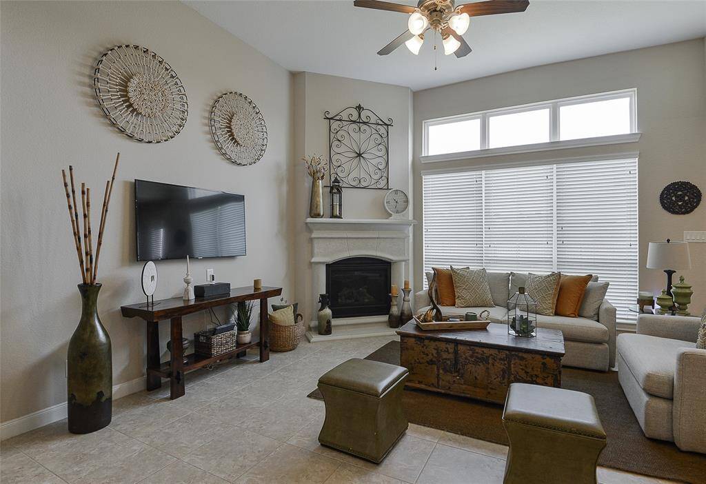 The fireplace serves as the centerpiece of this living room, creating a warm and inviting atmosphere that adds both charm and comfort to the space.