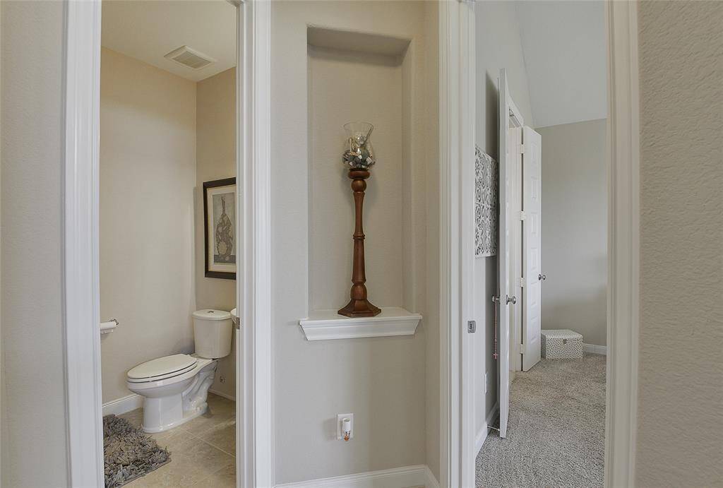 The half bath is conveniently located on the main floor, offering easy access for guests and everyday use without compromising privacy.