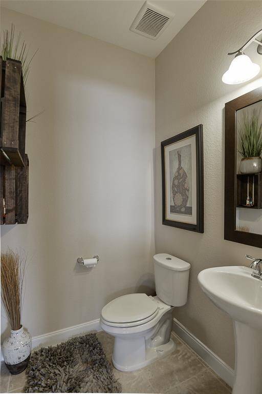 The half bath is conveniently located on the main floor, offering easy access for guests and everyday use without compromising privacy.