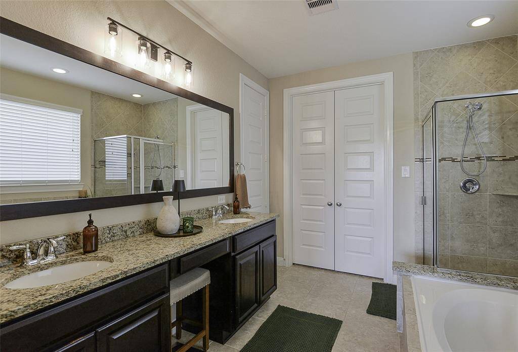 The double vanity in the primary bathroom offers ample space for two, combining functionality with comfort for a seamless morning and evening routine.
