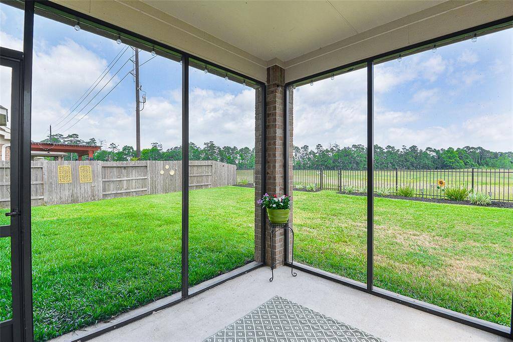 Relax or entertain year-round on the covered and encased patio—offering a comfortable, shaded retreat with added protection and privacy for any occasion.