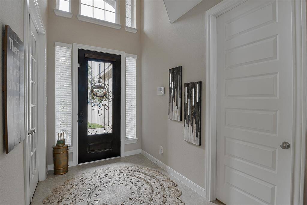 Tall 6 panel interior doors finished in white trim.