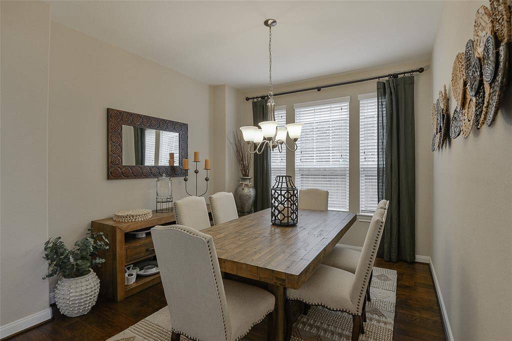 The formal dining room features elegant wood floors, adding warmth and sophistication—perfect for hosting dinners and special occasions in style.
