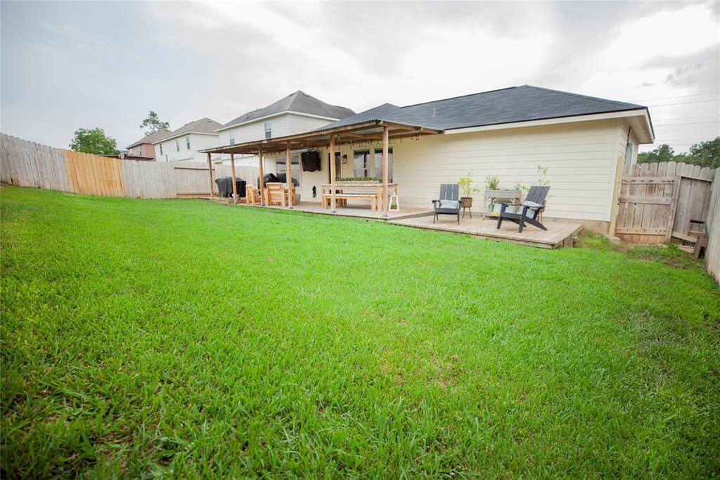 This backyard is thoughtfully designed for both relaxation and entertaining. The expansive grassy area is ideal for play, pets, or future garden beds.