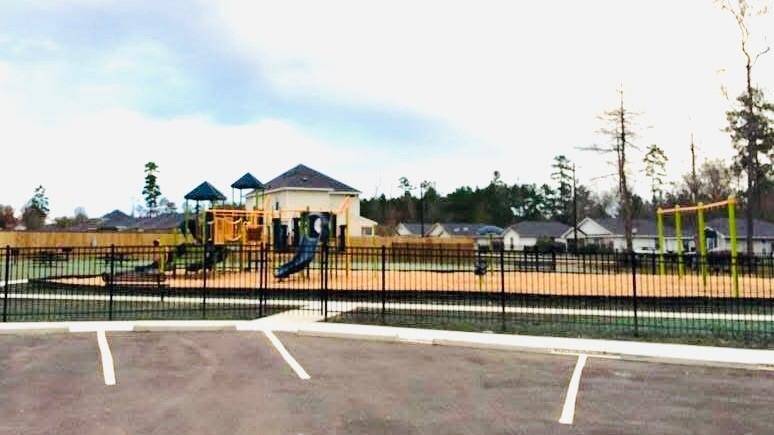 The fully fenced playground features swings, slides, and climbing structures, providing a safe and fun space for children to play and families to gather. With open green areas and a welcoming atmosphere, the Caddo Village park adds to the charm and livability of this family-friendly community.