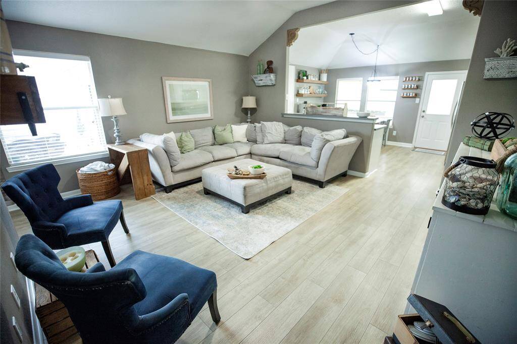 The space flows naturally into the kitchen and dining area, with ample natural light from the large window and back door.