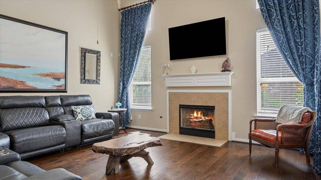 Living room with hardwood floors and gas fireplace