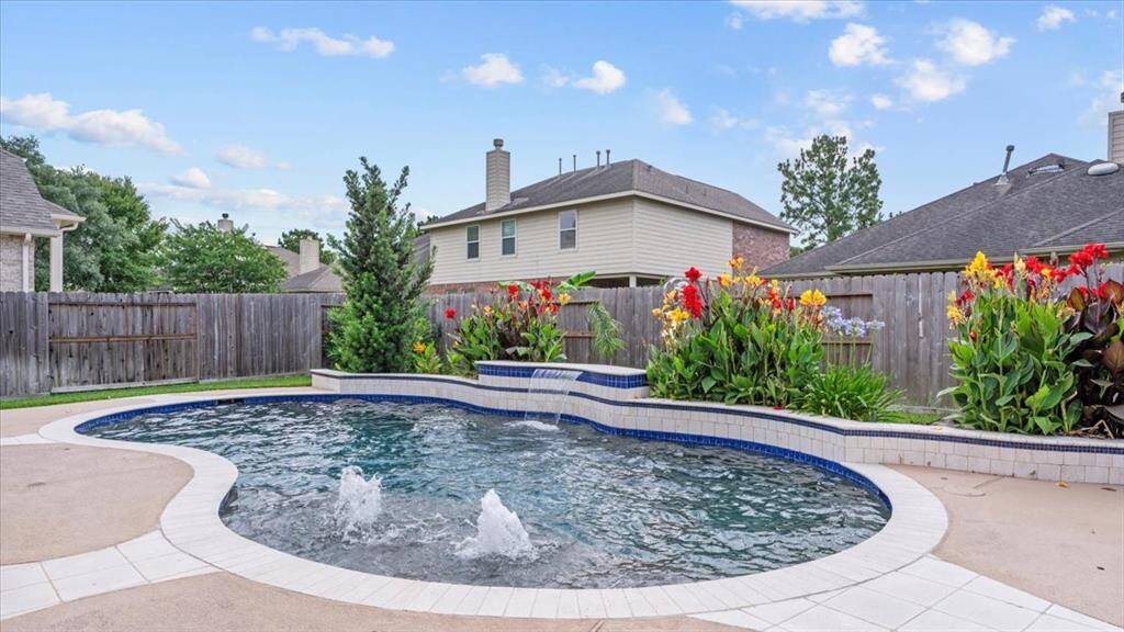 Heated pool with tanning ledge and waterfall