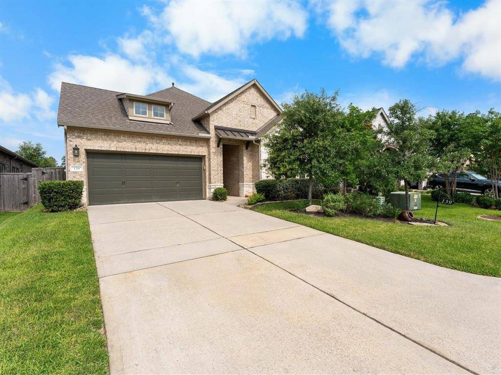 Beautiful curb appeal with well-maintained landscaping and extended driveway.