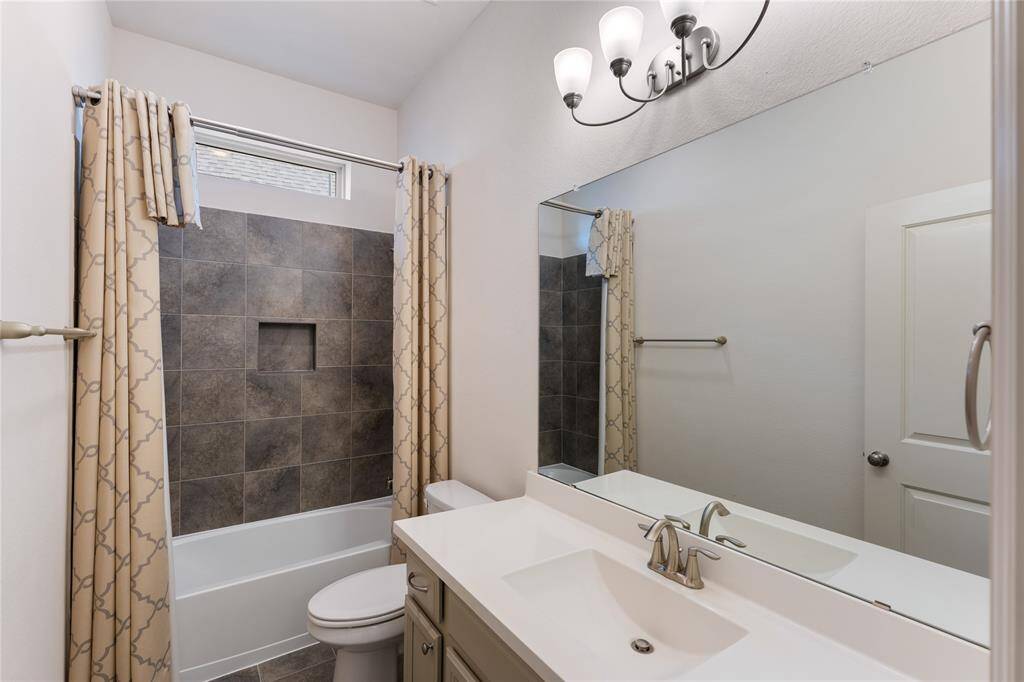 Secondary bath with double sinks and a tub/shower combo