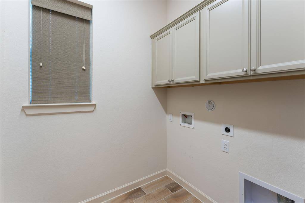 Large laundry room with built-in cabinetry and ample space.