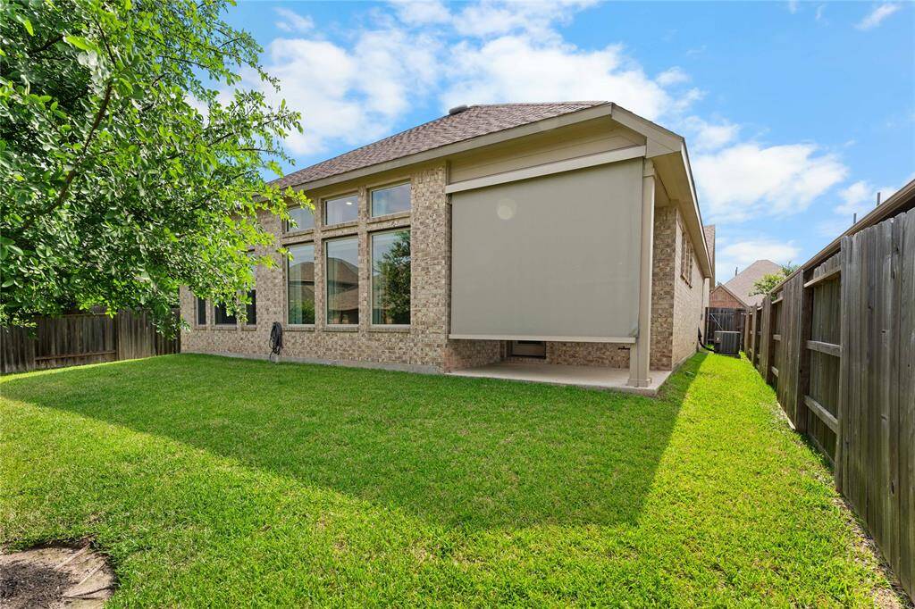 Covered patio with remote-controlled shade—perfect for relaxing or entertaining.