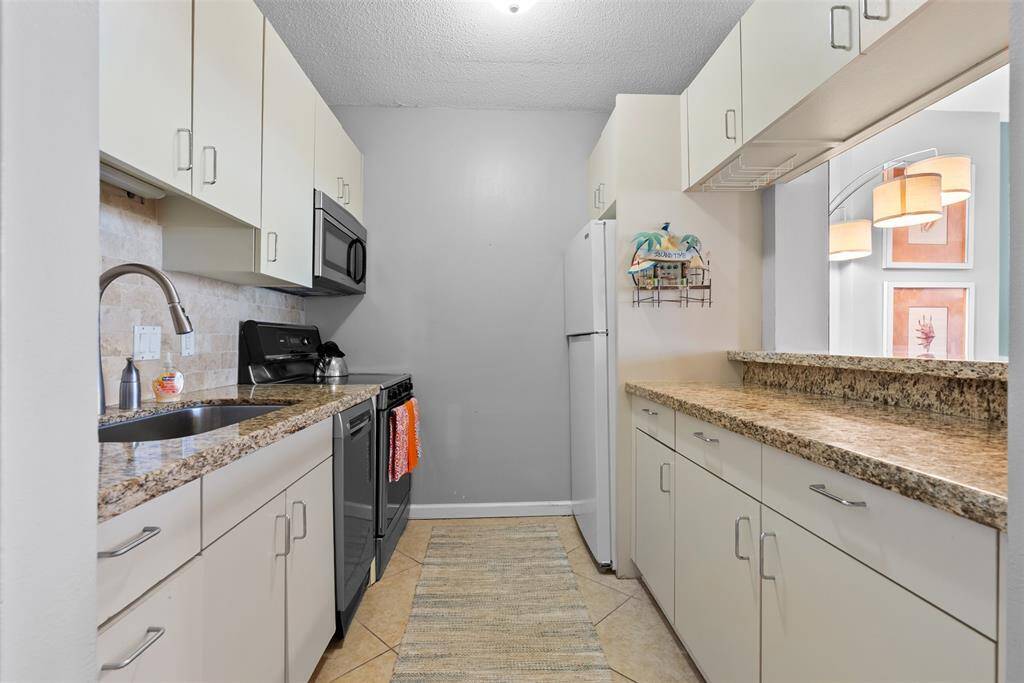 Kitchen opens to dining area.Efficient kitchen with all cups , plates , cookware , etc provided