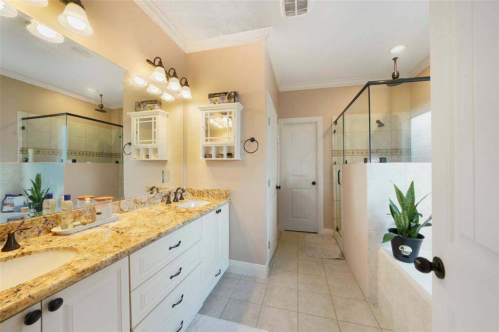 Master Bathroom- Features double sinks with granite countertops, a large dressing mirror, a spacious shower and separate soaking tub