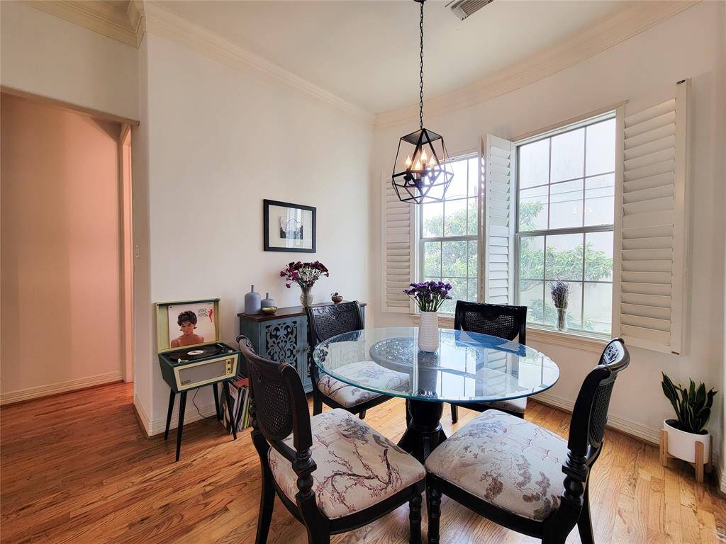This dining area features a stylish pendant light complemented by shutters and a cozy atmosphere.