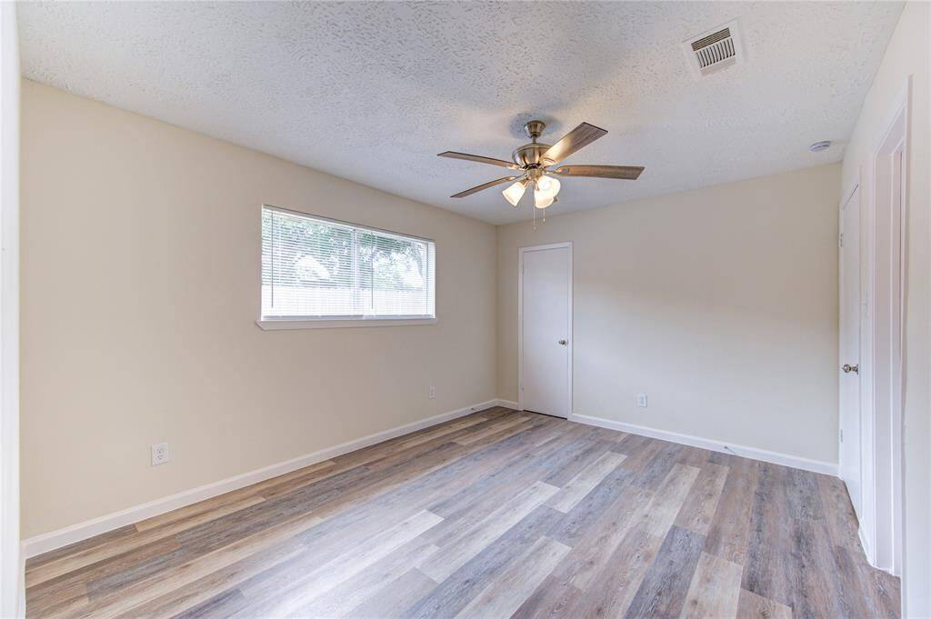 Primary Bedroom.  All bedrooms have blinds and new ceiling fans.  The primary bedroom has a walk-in closet and ensuite bathroom!
