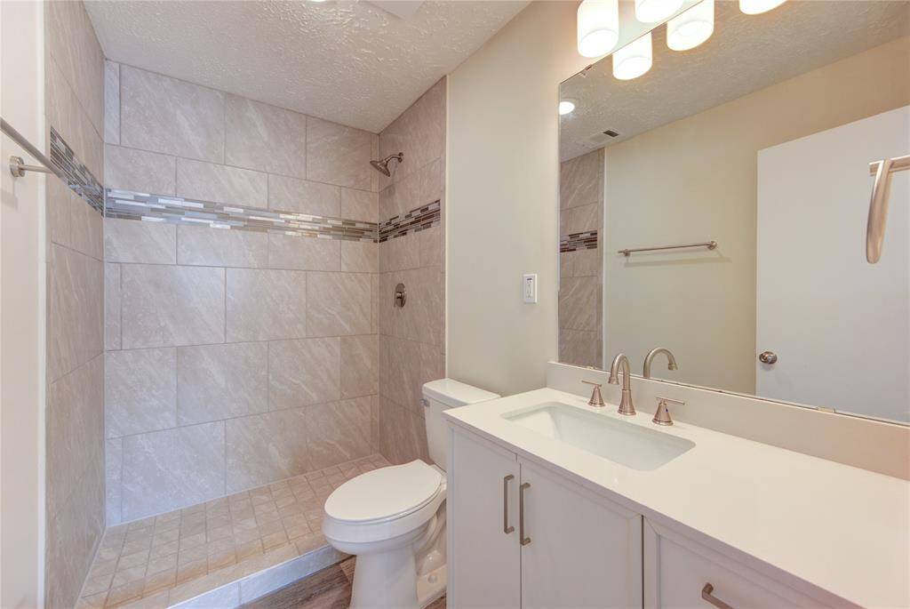 Primary bathroom has all new shower with decorativo glass mosaic inserts and a new toilet.  All bathrooms have new vanity cabinets with counters, new sinks and faucets, new mirrors and light fixtures and new towel bars and cabinet hardware!