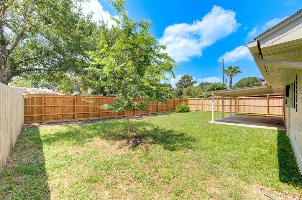 Large back yard with newer fencing.