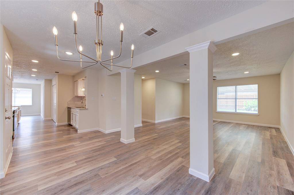 Formal dining looking toward kitchen and family room. The interior spaces have been opened as much as possible to allow for better natural light and openness.