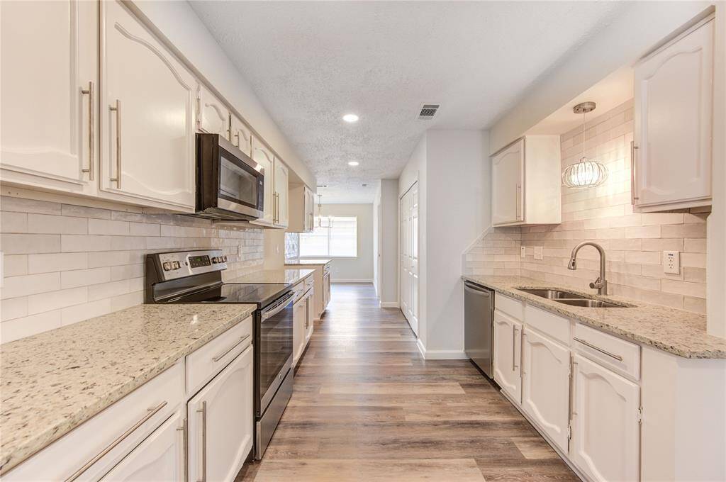 Large kitchen with gorgeous updates!  The updates include new granite and backsplash, new sink and faucet, new appliances, new LED recessed lighting and light fixtures and new cabinet handle pulls.